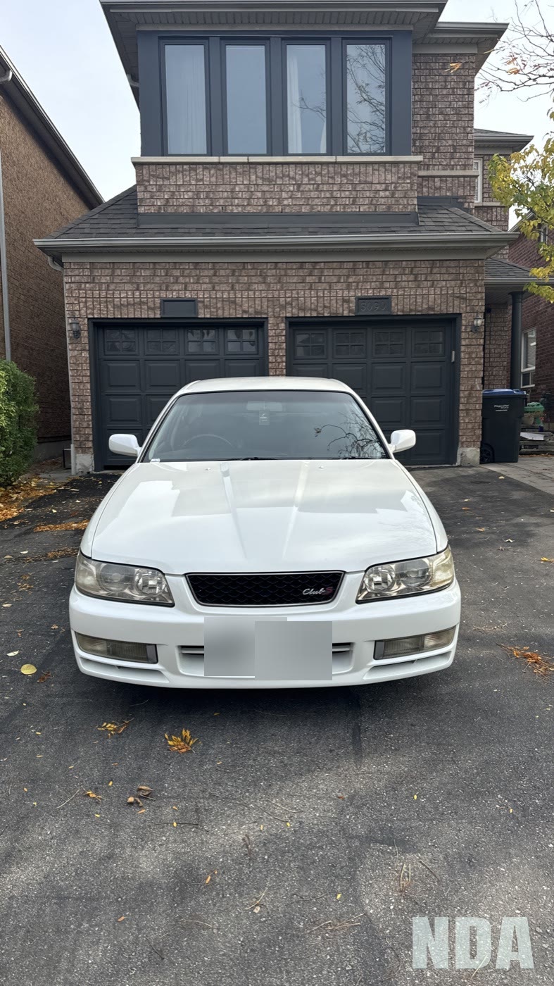 white Nissan Laurel