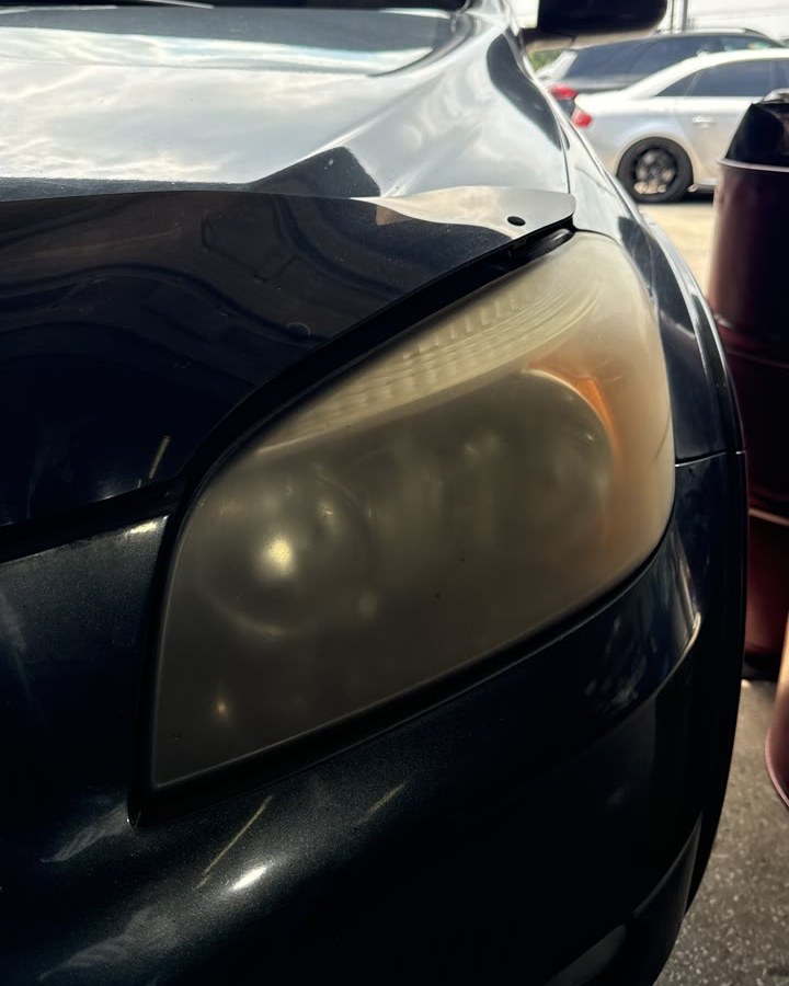 The headlight lens before: clouded and yellowed right through